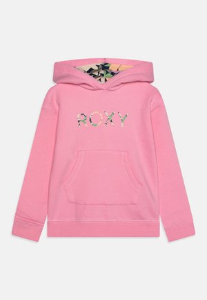 Lyserød hættetrøje lavet af blødt stof med en frontlomme og hætte. "ROXY"-logo i flerfarvet blomsterprint på brystet.