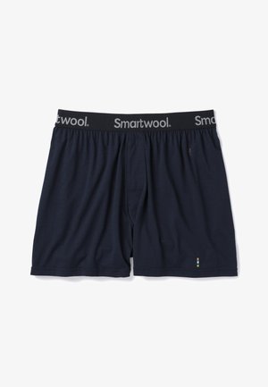 Mørkeblå bomuldsboxershorts med elastisk talje, der har "Smartwool"-logoet i grå. Inkluderer en lille, farverig accent.
