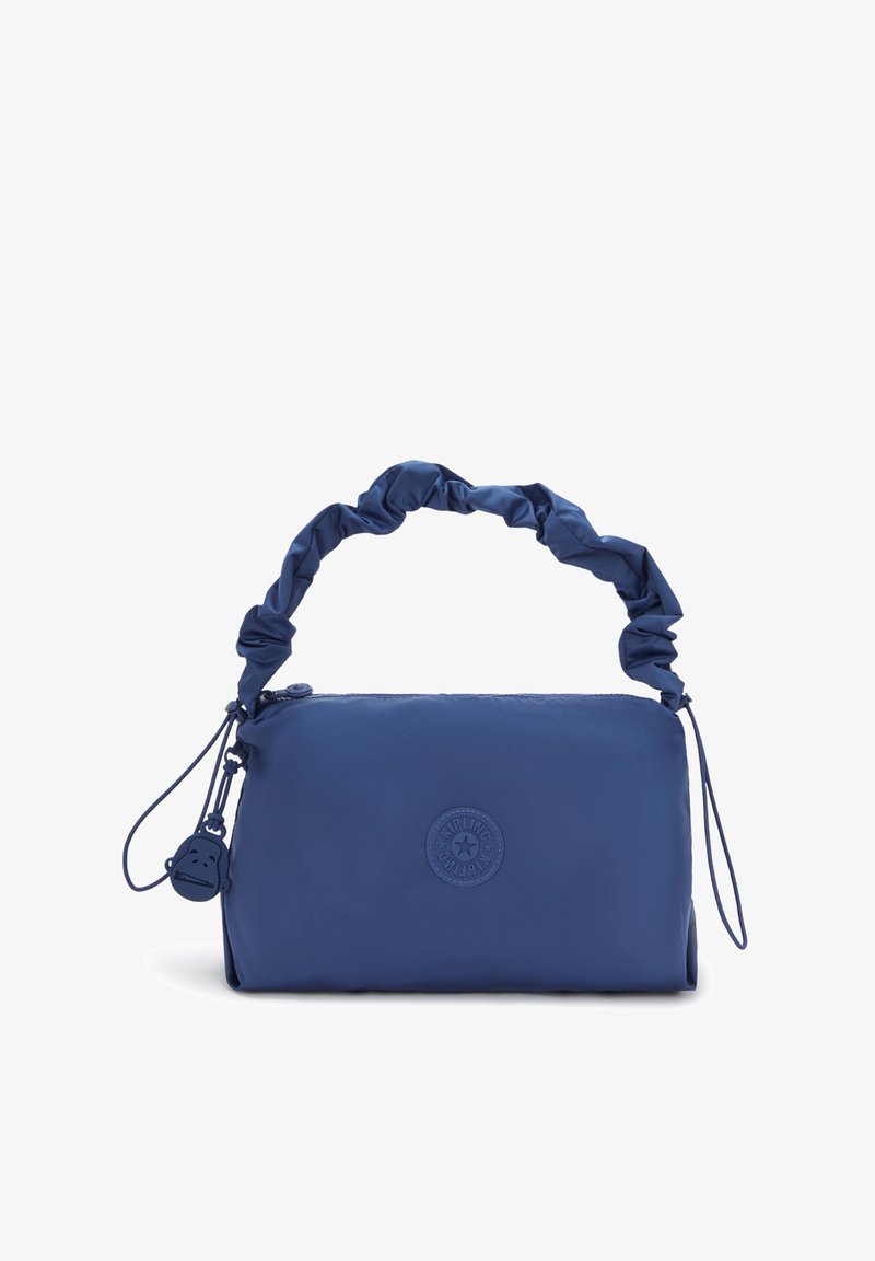 Námořnicky modrá taška s měkkou, hladkou texturou, vybavená střiženým uchem, zipovým zapínáním a kulatým logem na přední straně.