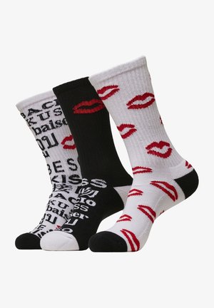 Witte en zwarte sokken met patronen: eentje met rode lippen op wit, de andere met tekst op zwart. Katoenen mix, geribbelde structuur, crew lengte.