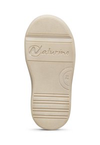 Suola di scarpa in gomma color crema con superficie texturizzata, caratterizzata da scanalature orizzontali e verticali, e logo "Naturino" impresso.