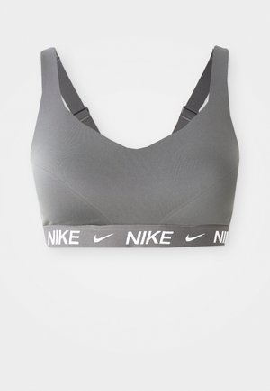Gray sports bra with a smooth texture, wide black band featuring white "Nike" logo, adjustable straps, and a v-shaped neckline.