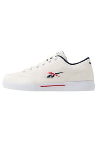 Zapatilla de lona blanca con acentos en azul y rojo, que presenta seis ojetes, cordones planos, una suela acolchada y un logo en el costado.