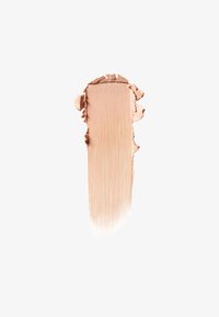 Beige makeup foundation smear with smooth center and textured edges on a plain white background.