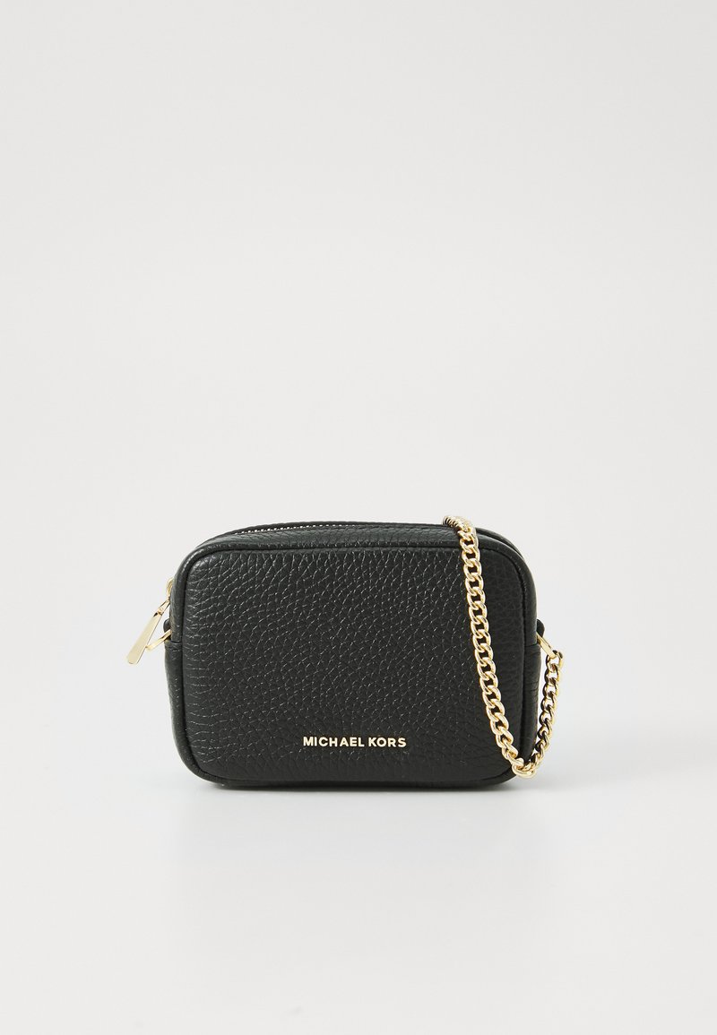Black leather crossbody bag with a textured surface, gold chain strap, zip closure, and gold logo lettering on the front.