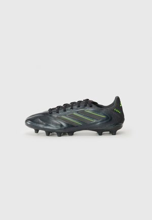 Black football boot with textured synthetic upper, neon green accents, lace-up design, and rounded toe. Six black studs for traction.