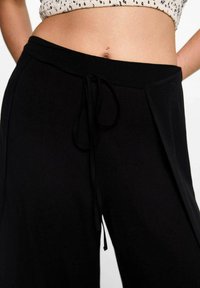 Mango Kids Hlače - black