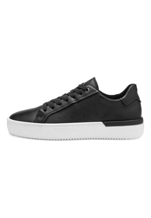 Black low-top leather sneaker with black laces, white thick rubber sole, and textured design on the side and heel.