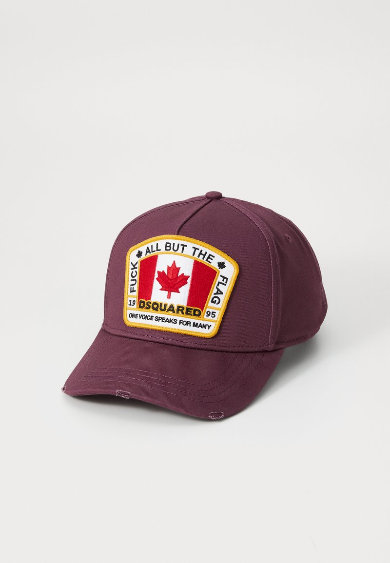Maroon baseball cap with a curved brim, featuring an embroidered patch of the Canadian flag and text in yellow on the front.