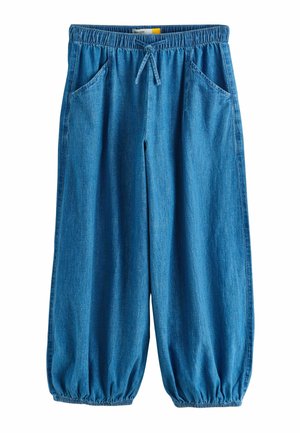 Blue denim loose-fit pants with elastic waistband, drawstring, side pockets, and elastic cuffs at ankles.