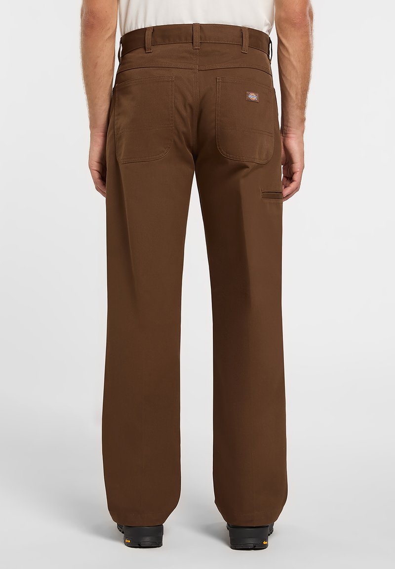 Brown work pants with a relaxed fit, made of durable fabric, featuring two back pockets and a side pocket. Flat front with belt loops.