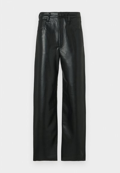 Mustad nahast püksid sirge lõikega, millel on nööpidega sulgemine, vööaasad ja kaks esitaskut. Sile pind kergelt läikiva tekstuuriga.