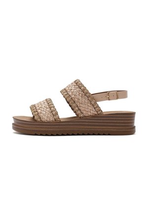 Woven fabric sandals with two wide straps, beige color with green accents, and a brown layered sole featuring a zigzag pattern.