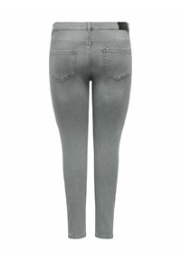 Sive skinny jeans iz jeansa z gladko teksturo. Značilna klasična zasnova s petimi žepi in subtilna črna oznaka na pasu.