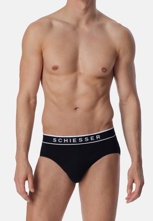 Schwarze Unterhosen aus weichem Stoff mit einem weißen "SCHIESSER"-Logo auf dem elastischen Bund. Für eine enganliegende Passform konzipiert.