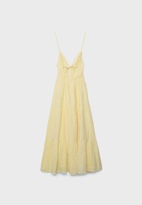Robe maxi jaune clair sans manches avec fines bretelles spaghetti, décolleté en V, lien à nouer à l'avant et jupe à volants.
