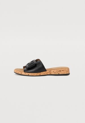 Black slide sandal with a cork sole, featuring a wide strap and rectangular buckle detail. Smooth leather upper with a flat, open design.