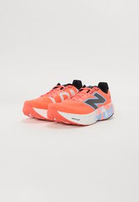 Bright coral running shoes with black accents, mesh upper, and white soles featuring a blue and coral patterned design. Prominent 'N' logo.