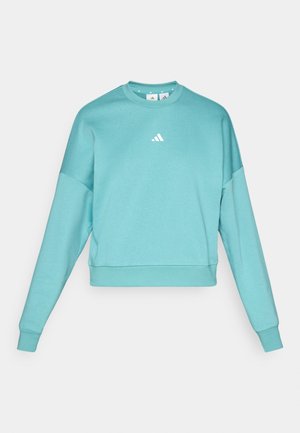 Turkise sweatshirt med lange ærmer og rund hals. Har et hvidt logo på brystet og en glat stoftekstur.