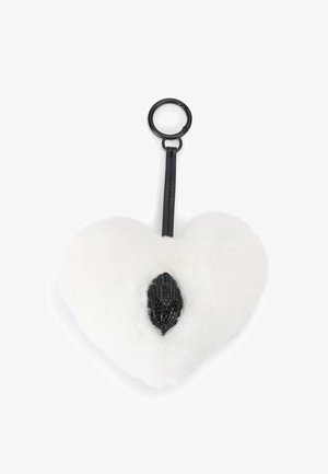 White faux fur heart-shaped keychain with a black feather-shaped accent. Includes a black strap and circular metal ring for attachment.