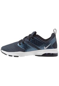 Men’s dark blue Nike athletic shoe with black laces, white sole, and transparent air cushion in heel, side view on white background.