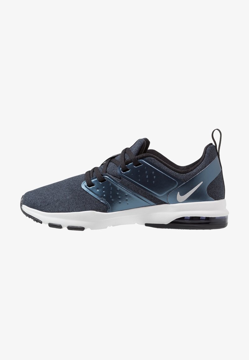 Men’s dark blue Nike athletic shoe with black laces, white sole, and transparent air cushion in heel, side view on white background.