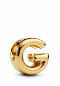 Scultura in metallo dorato a forma di lettera "G" con superficie liscia e riflettente e bordi arrotondati, che presenta un design moderno.