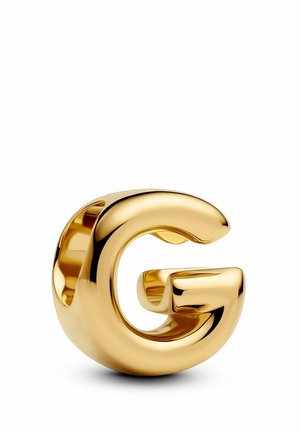 Goldfarbene Metallsch sculpture in Form des Buchstabens "G" mit einer glatten, reflektierenden Oberfläche und abgerundeten Kanten, die ein modernes Design zeigt.