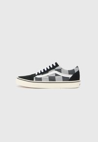 Black and white plaid canvas sneakers with a black suede toe cap, white laces, and cream rubber sole. Features a signature side stripe design.