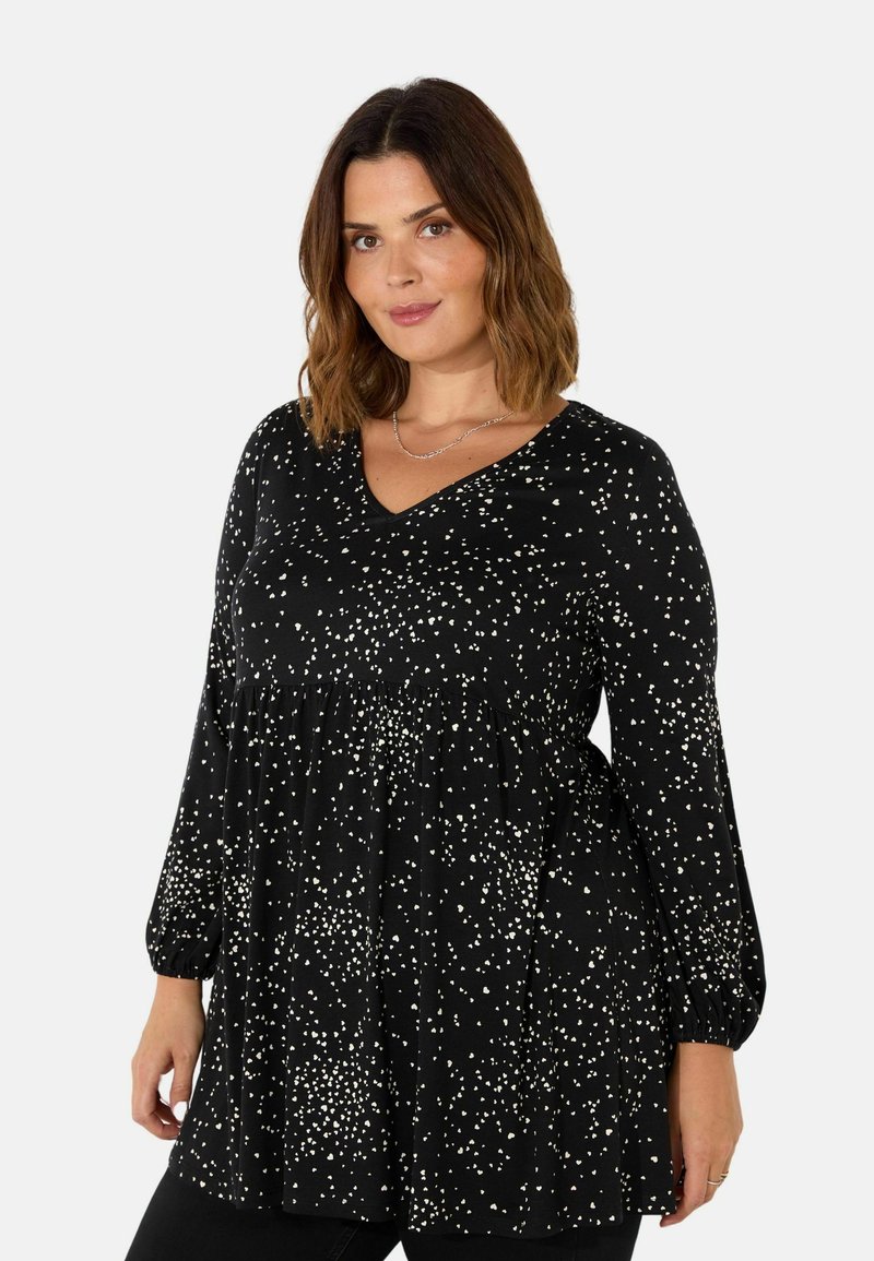 Black long-sleeve top featuring a V-neck, dotted white pattern, gathered waist, and elastic cuffs. Made of lightweight, soft fabric.