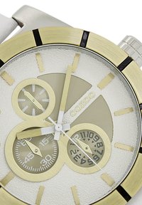 Montre argent et or avec un cadran blanc texturé, comportant trois sous-cadrans, des marqueurs d'heure dorés et une aiguille des secondes centrale blanche.