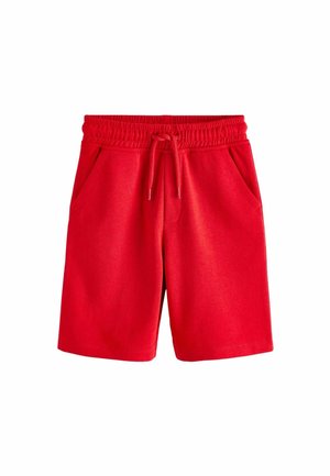 Shorts en coton rouge avec une taille élastique, un cordon ajustable et deux poches latérales ; texture lisse, design jusqu'aux genoux.