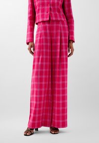 Pink plaid blazer and wide-leg pants set, made of soft fabric with a smooth texture. Features a checkered pattern and minimalistic design.