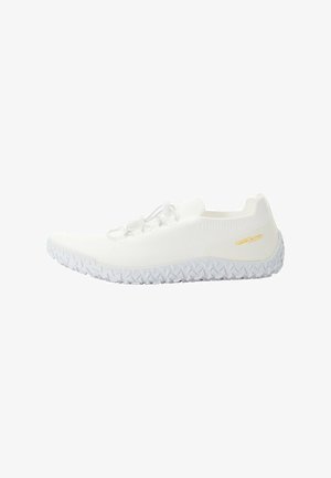 White athletic shoes with a mesh upper, elastic laces, and a textured rubber sole featuring a geometric pattern. Notable brand accent in gold.