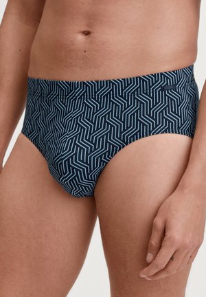 Navyblauwe zwemslips met een geometrisch patroon in lichtblauw. De stof is glad, ontworpen voor comfort met een aansluitende pasvorm.