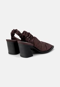 Pair of dark brown ruched fabric slingback heels with wide black block heels on a plain white background.