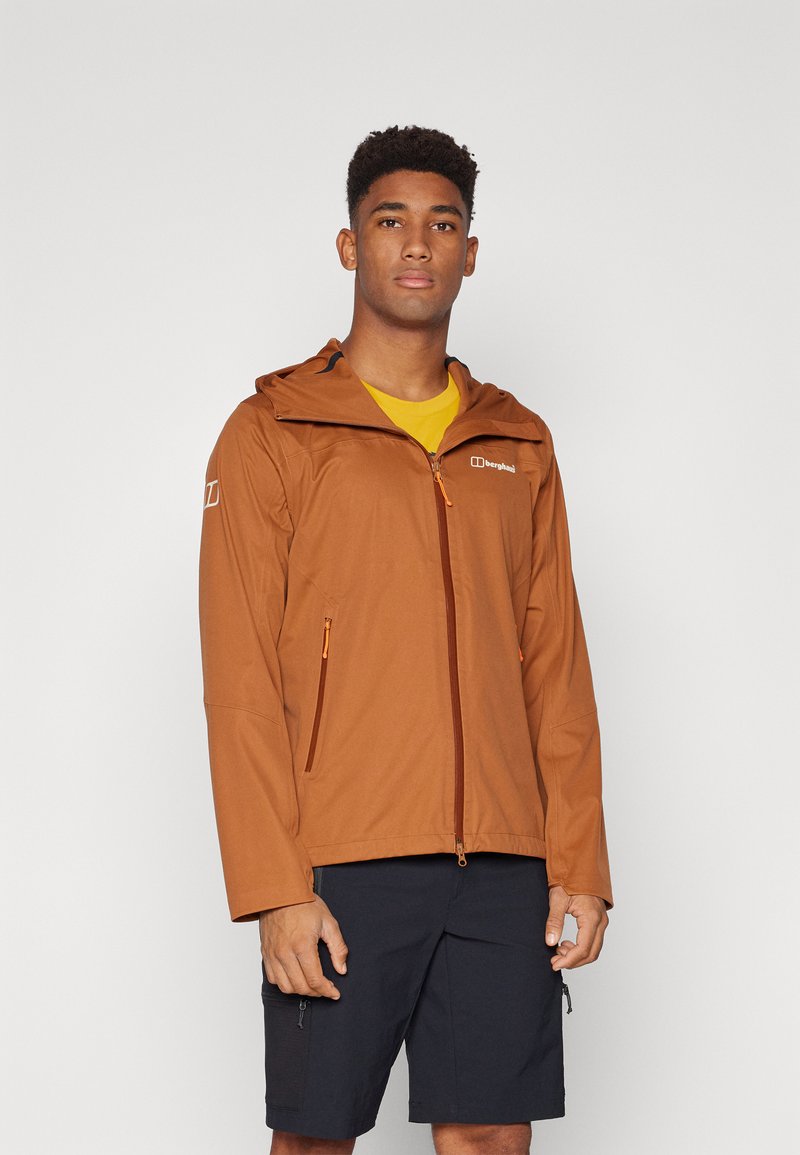 Brown waterproof jacket with a hood, front zipper, and side pockets. Features orange accents and a logo on the chest. Lightweight, sleek design.