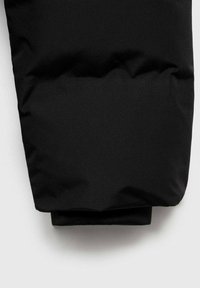 Black puffer jacket sleeve with a smooth, shiny texture; thick insulating material; understated design with a folded cuff.