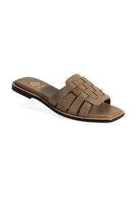 Sandale à glissière en cuir marron avec design de bride tressée, bout ouvert et semelle plate. Style minimaliste avec un logo subtil sur la semelle intérieure.