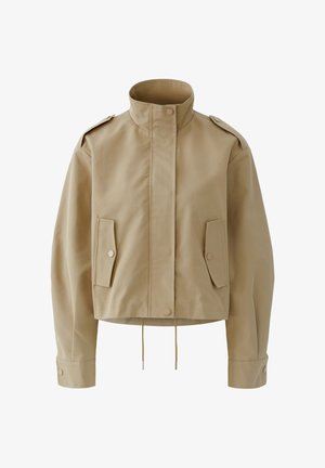 Beige cropped jacket with high collar, front snap buttons, flap pockets, shoulder epaulets, long sleeves, and drawstring hem.