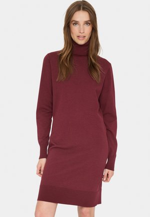 Burgunderfarbiges Strickkleid mit hohem Rollkragen, langen Ärmeln, gerippten Bündchen und Saum. Verfügt über ein einfaches, tailliertes Design mit seitlichen Schlitzen.