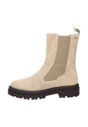 Botte cheville beige en daim avec panneau latéral en élastique côtelé, tirette à l'arrière et semelle épaisse à motif noir.