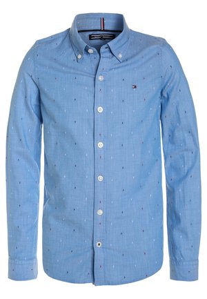Camicia azzurro chiaro manica lunga con bottoni, con piccoli punti ricamati rossi, bianchi e blu navy e logo Tommy Hilfiger sul petto.