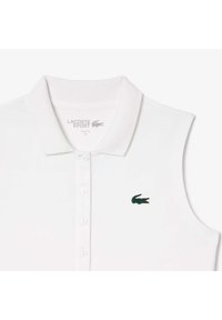 Polo shirt bianco senza maniche realizzato in cotone; presenta un logo coccodrillo ricamato verde e una chiusura a tre bottoni; design slim fit.