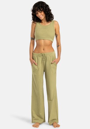 Light green, cropped tank top with a round neckline and matching loose-fit pants featuring side pockets and drawstring waist. Soft texture.