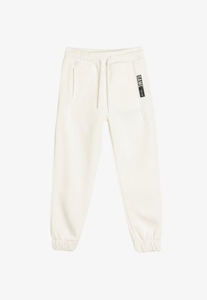 Witte joggerbroeken van zacht materiaal, met een elastische tailleband, zijzakken en een klein zwart label op de voorkant.