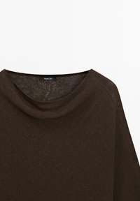 Dark brown textured loose-fit top with a round neckline, made of lightweight fabric.