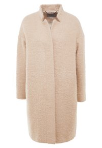 Cappotto oversize beige realizzato in tessuto testurizzato, con colletto e maniche lunghe, dalla linea dritta e senza chiusure visibili.