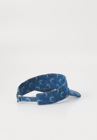 Denim visor cap with a curved brim, featuring a repeating light blue pattern. The adjustable strap is at the back, with visible stitching.