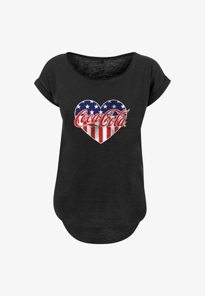 Black scoop neck T-shirt with rolled sleeves, featuring a heart-shaped American flag and red Coca-Cola logo centered on the front.